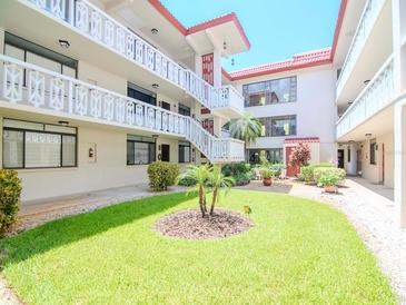 Well-maintained courtyard with lush landscaping and building access at 2612 Pearce Dr # 304, Clearwater, FL 33764