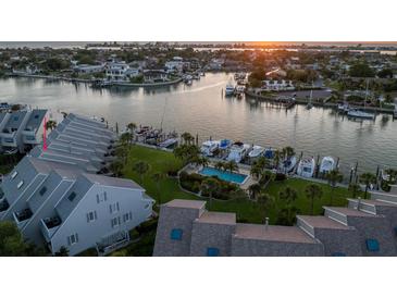Aerial view of waterfront condo community with pool and boat slips at 370 Pinellas Bayway S # E, Tierra Verde, FL 33715