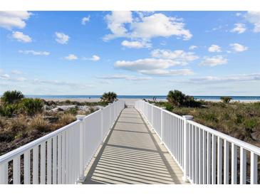 White walkway leads to a beautiful beach at 1200 Gulf Blvd # 206, Clearwater Beach, FL 33767