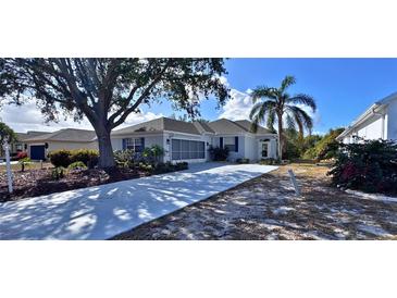 Single-story home with landscaped yard and driveway at 1333 Misty Greens Dr, Sun City Center, FL 33573