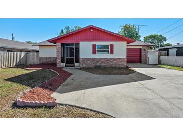Charming single-Gathering home with red trim and a well-maintained front yard at 2233 Curlew Rd, Dunedin, FL 34698