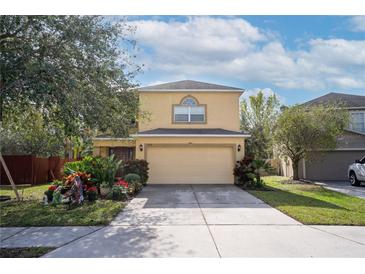 Charming two-story home with a two-car garage, driveway, and a well-maintained lawn and garden at 9703 33Rd E Ave, Palmetto, FL 34221