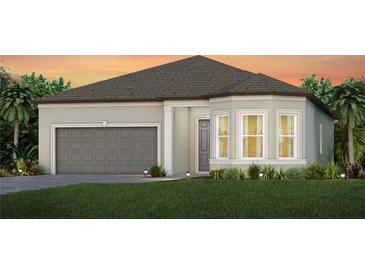 Single-story home with gray garage door and landscaping at 11216 Shoreline Trl, Parrish, FL 34219