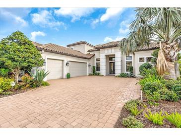 Beautiful single-Gathering home with a three car garage, a tile roof, and a brick driveway at 4825 Benito Ct, Bradenton, FL 34211