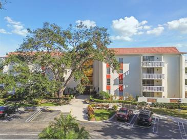Stunning exterior view of condo building boasting well maintained landscaping and ample parking at 2650 Pearce Dr # 301, Clearwater, FL 33764
