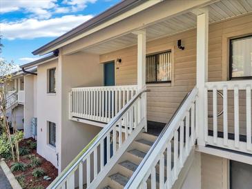 Exterior view of condo building showcasing stairs and entrance at 3714 Greenery Ct # 214, Tampa, FL 33618