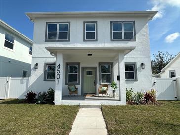 Two-story house with white exterior, covered porch, and landscaping at 4501 21St N St, St Petersburg, FL 33714