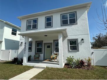 Two-story house with white exterior, covered porch, and landscaping at 4501 21St N St, St Petersburg, FL 33714