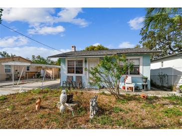 Light blue house with carport and small front yard at 8416 N Semmes St, Tampa, FL 33604