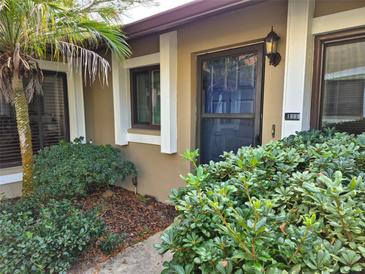 Inviting front entrance with lush landscaping and a charming walkway at 1669 Fry Ct, Dunedin, FL 34698