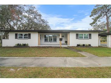 Updated ranch home with fresh paint, modern entryway, and carport at 6602 S Emerson Ave, St Petersburg, FL 33707