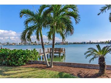 Waterfront view with private dock and lush landscaping at 16323 Redington Dr, Redington Beach, FL 33708