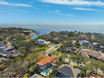 Stunning aerial view of waterfront homes, lush landscaping, and bay access in a desirable community at 1388 Brightwaters Ne Blvd, St Petersburg, FL 33704