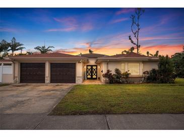 Beautiful home with 2-car garage, attractive landscaping, and a welcoming entryway at 2790 Pinellas Point S Dr, St Petersburg, FL 33712