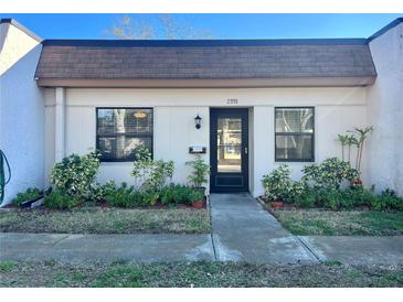 Inviting condo exterior with well-manicured landscaping and a private entrance at 2991 Flint S Dr # 77-D, Clearwater, FL 33759