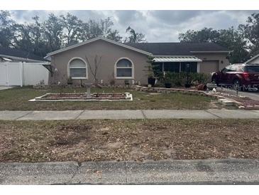 Ranch-style home with landscaped yard and driveway at 515 Cottage Ln, Brandon, FL 33510