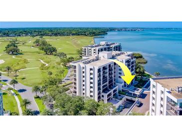 Aerial view of waterfront condo building with golf course and bay views at 6 Belleview Blvd # 105, Belleair, FL 33756