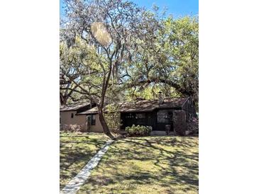 House exterior with a large yard and mature trees at 1505 E Park Cir, Tampa, FL 33610