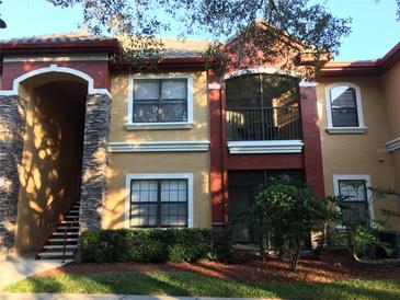 Two-story condo building with stone accents and balconies at 2171 Portofino Pl # 27-2717, Palm Harbor, FL 34683