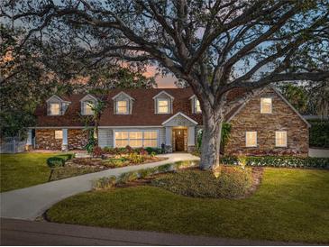 Stunning two-story home with stone accents and a manicured lawn at 307 Harbor View Ln, Largo, FL 33770