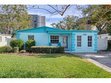 Charming light blue house with a well-manicured lawn at 6210 S Harold Ave, Tampa, FL 33616