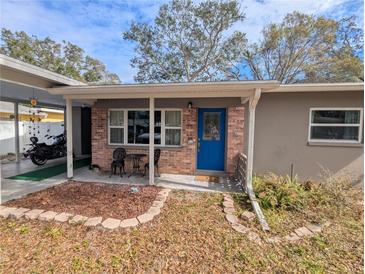 Inviting house exterior featuring a covered porch and brick facade at 700 16Th Nw St, Largo, FL 33770