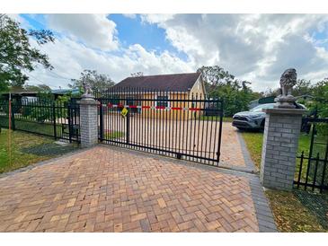 Attractive home with gated entry and brick driveway at 7211 Waycross Ave, Tampa, FL 33619