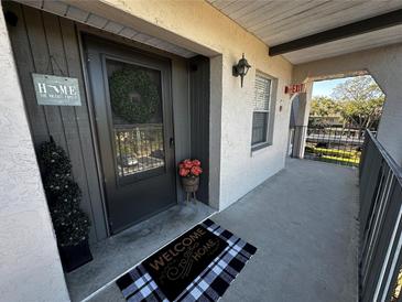 Inviting entryway with a bench, decorative pillows, and a round table with a flower arrangement at 8765 Bardmoor Blvd # 308, Seminole, FL 33777