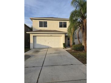 Two-story house with attached garage and driveway at 12954 Fennway Ridge Dr, Riverview, FL 33579