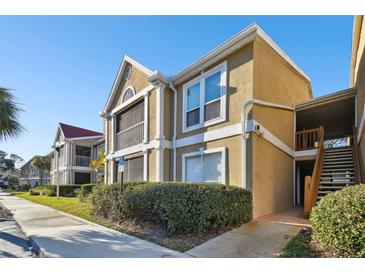 Two-story condo building with red tile roofs and landscaping at 9481 Highland Oak Dr # 807, Tampa, FL 33647