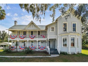 Two-story historic home with wrap-around porch and expansive lawn at 301 Old Hopewell Rd, Plant City, FL 33567