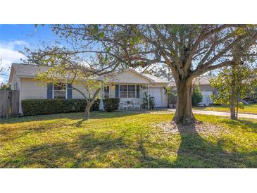 Charming single story home with mature landscaping and a spacious front yard at 1517 Young Ave, Clearwater, FL 33756