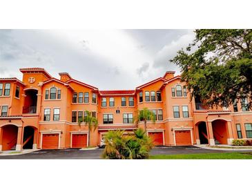 Attractive three-story building with orange stucco and red tile roofs at 2729 Via Murano # 437, Clearwater, FL 33764