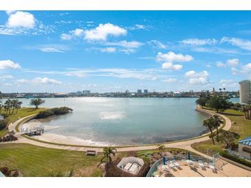 Aerial view of waterfront property with a community pool and lush landscaping at 7902 Sailboat Key S Blvd # 405, South Pasadena, FL 33707