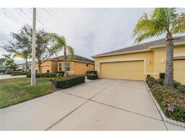 Two-car garage villa with landscaped yard and driveway at 2311 Nottingham Greens Dr # 2311, Sun City Center, FL 33573