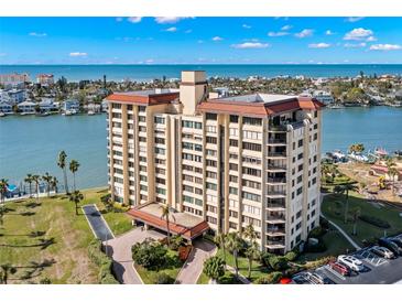 Aerial view of a waterfront condo building with a pool and parking at 700 Island Way # 704, Clearwater Beach, FL 33767