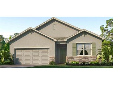 Single-story house with a two-car garage and stone accents at 1716 Tahitian Sunrise Dr, Plant City, FL 33565