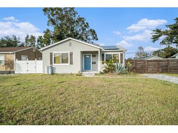 Charming bungalow with a new gray exterior, blue door, and modern fence at 175 83Rd N Ave, St Petersburg, FL 33702