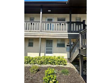 Condo building exterior with entrance and landscaping at 5207 Turquoise Ln # 202, New Port Richey, FL 34652