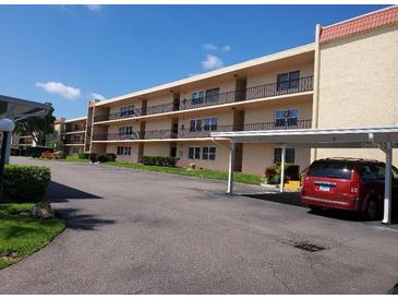 Two-story condo building with parking and landscaping at 12200 Vonn Rd # 2109, Largo, FL 33774