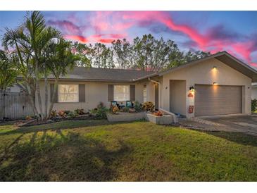 Charming single-story home with landscaped yard and attached garage at 1597 Franklin Way, Dunedin, FL 34698