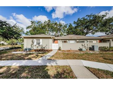 Tan single story home with white fence and walkway at 11805 Northtrail Ave, Temple Terrace, FL 33617
