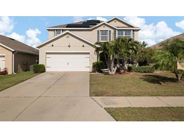 Two-story house with a large driveway and palm trees at 5119 11Th E St, Bradenton, FL 34203