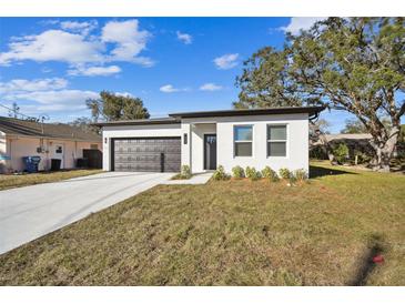 Newly constructed home with a two-car garage and well-manicured lawn at 7453 Blackhawk Trl, Spring Hill, FL 34606