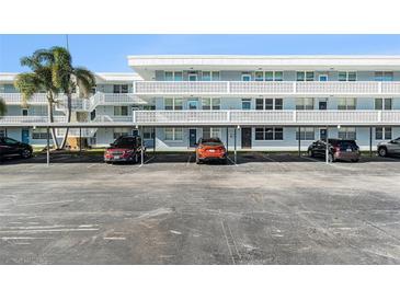 Exterior view of condo building with assigned parking spaces at 4880 Locust Ne St # 227, St Petersburg, FL 33703