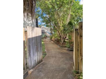 Inviting walkway leading through a lush, green courtyard at 4902 31St S Ave # 109, Gulfport, FL 33707