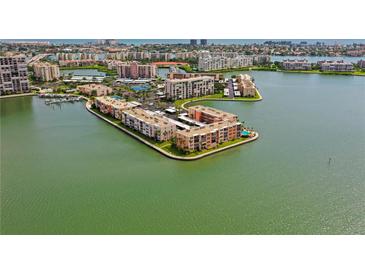 Aerial view of waterfront condo building with parking and pool at 7645 Sun Island S Dr # 207, South Pasadena, FL 33707