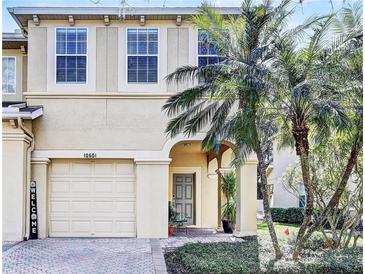 Charming two-story home with attached garage, front door, and beautiful landscaping at 10601 Shady Falls Ct, Riverview, FL 33578