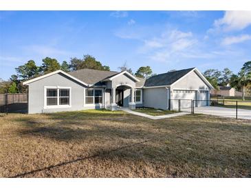 Newly constructed home with attached garage and fenced yard at 12332 Harris Hawk Rd, Weeki Wachee, FL 34614
