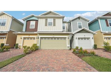 Charming multi-colored townhouses with brick paved driveway and two car garages at 6324 Camino Dr, Apollo Beach, FL 33572